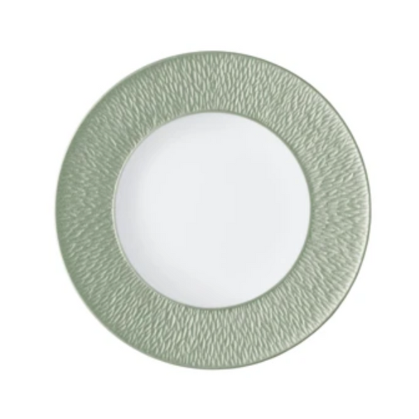 A Raynaud Mineral Irise Dinnerware - Celadon plate is shown from above, with a textured light green rim and smooth white center, set against a plain background.