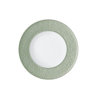 A round Limoges porcelain plate from Raynaud’s Mineral Irise Dinnerware - Celadon, featuring a textured light green rim and smooth white center, is displayed against a plain white background.