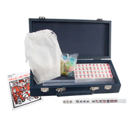 The Brouk & Co Mini Travel Mahjong Set includes a black case, white drawstring bag, colorful chips, Mahjong tiles, a guidebook, and an exterior tile display—perfect for beginners and playing anywhere.