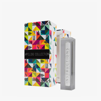 A Modern Acrylic Mezuzah Case 4.5" by Apeloig Collection stands beside a colorful, geometric-patterned Apeloig Collection box and includes a clear holder with a white instructions card.