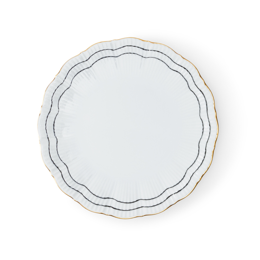 The Coral Dinnerware Black by Molecot is a white porcelain plate with scalloped edges, detailed with two black lines and a gold accent near the rim, displayed on a white background.