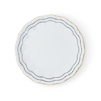 The Coral Dinnerware Black by Molecot is a white porcelain plate with scalloped edges, detailed with two black lines and a gold accent near the rim, displayed on a white background.