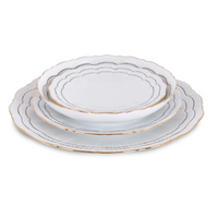 Three sophisticated black Molecot Coral Dinnerware plates, stacked by size. Each features scalloped edges with a gold rim and a subtle gray wavy line design along the border.