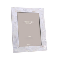 The Addison Ross Mother Of Pearl White Frame is a rectangular photo frame featuring a glossy, mosaic-like white and pearl finish. It is shown standing at an angle with a blank placeholder inside.