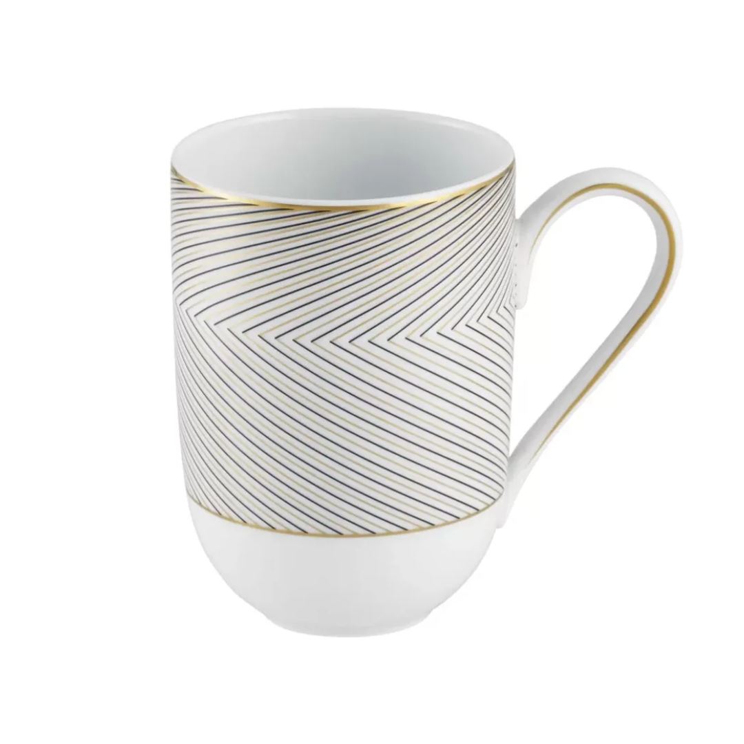 The Oskar Dinnerware mug by Raynaud is a white ceramic piece inspired by Limoges porcelain, featuring a gold rim and handle with a geometric black herringbone pattern of thin diagonal lines.