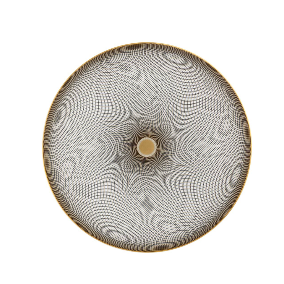 The Oskar Dinnerware by Raynaud features a circular design viewed from above, with an intricate spiraling black pattern radiating from a central beige circle and accented by a thin gold rim.