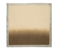 The Kim Seybert Dip Dye Napkins - Earthtones (Set of 4) feature a square design with a beige top that fades into dark brown, finished with a light gray border.