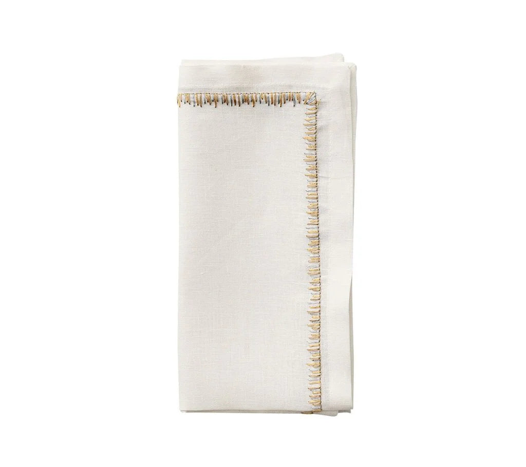 The Kim Seybert Filament Napkin Gold & Silver Set of 4 features embroidered linen napkins with elegant contrasting stitching, perfect for festive tablescapes. Shown neatly folded against a simple white background.