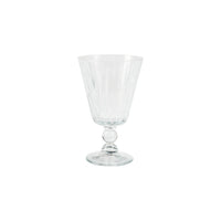 The Vietri Natalia Aperitivo Glass features a clear, faceted goblet with a flared bowl, short decorative stem, and round base, shown against a plain white background.