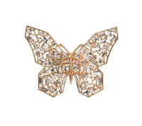 The Kim Seybert Papillon Butterfly Napkin Ring Boxed Set of 4 features gold, openwork butterfly designs adorned with sparkling crystals in geometric patterns—ideal as luxury table decor or elegant napkin rings. Displayed on a plain white background.