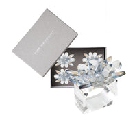 The Kim Seybert Spectra Napkin Ring Set of 4 in Glacier Blue features elegant crystal flower shapes, beautifully presented in a gray box—perfect for adding sophisticated style to your table décor.