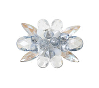 The Kim Seybert Spectra Napkin Ring Set of 4 in Glacier Blue features faceted clear and light blue gemstones arranged as petals with a clustered center—an elegant accent for your table décor or a unique crystal napkin ring.