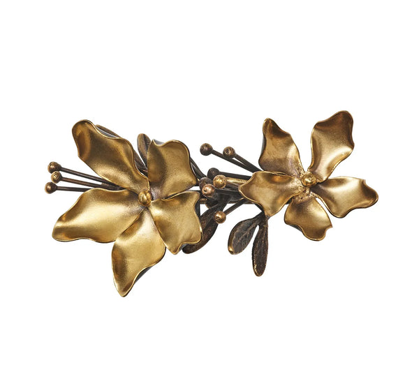 Magnolia Napkin Ring Set of 4 - Gold & Black featuring two burnished gold magnolia flowers with dark, slender stems and leaves.