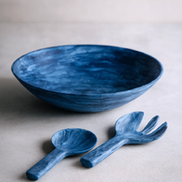 The Nashi Home Swirl Colored Resin Everyday Bowl comes with matching salad servers—a spoon and a fork—making it a stylish, shatterproof choice for handcrafted home decor enthusiasts.