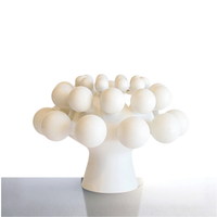 The KleinReid Nimbus Dome Vase Onyx is a modern, white sculptural vase from the nimbus collection, tree-shaped with spherical branches, handmade in porcelain and displayed on a reflective surface against a plain white background.