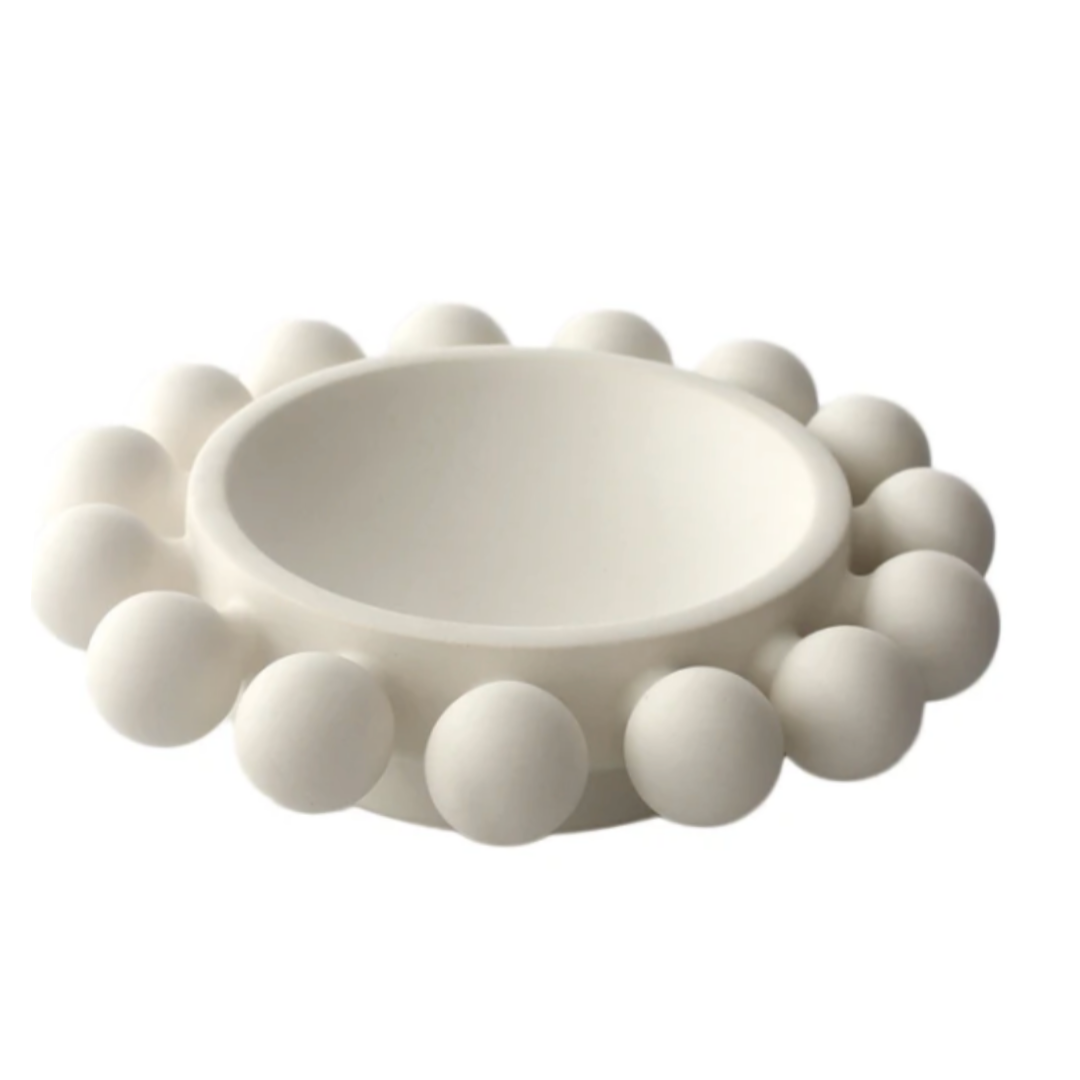 The KleinReid Nimbus Halo Bowl is a white, round piece from the Nimbus Collection, featuring smooth, evenly spaced spherical knobs around the outer rim on a plain white background.