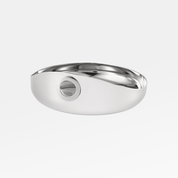 The Oh De Small Stainless Steel Bowl by Christofle features a sleek, modern oval design with a smooth, reflective finish and a unique circular cutout—perfect as a stylish multi-purpose bowl or wine coaster.