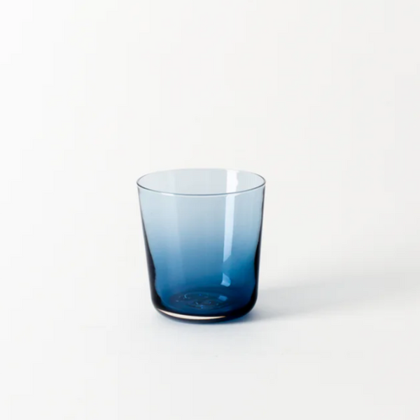 The Gary Bodker Everyday Glasses Midnight is a translucent blue, hand-blown tumbler with a simple cylindrical shape, shown on a plain white background.