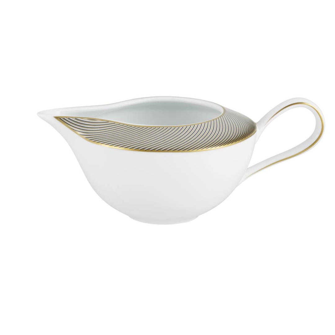 The Oskar Dinnerware gravy boat by Raynaud is crafted from white Limoges porcelain and features a curved handle with gold and black wavy line geometric designs along the rim.