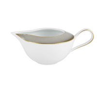 The Oskar Dinnerware gravy boat by Raynaud is crafted from white Limoges porcelain and features a curved handle with gold and black wavy line geometric designs along the rim.
