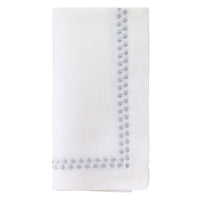 The Bodrum Pearls Napkin Silver Set of 4 is crafted from fine linen and features small, evenly spaced silver embroidered dots along two edges.