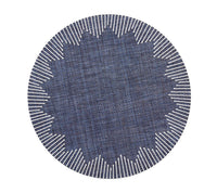The Kim Seybert Dream Weaver Placemat Set of 4 in Navy & White features round placemats with a zigzag inner pattern and radiating white border lines for a striking sunburst effect against a plain background.