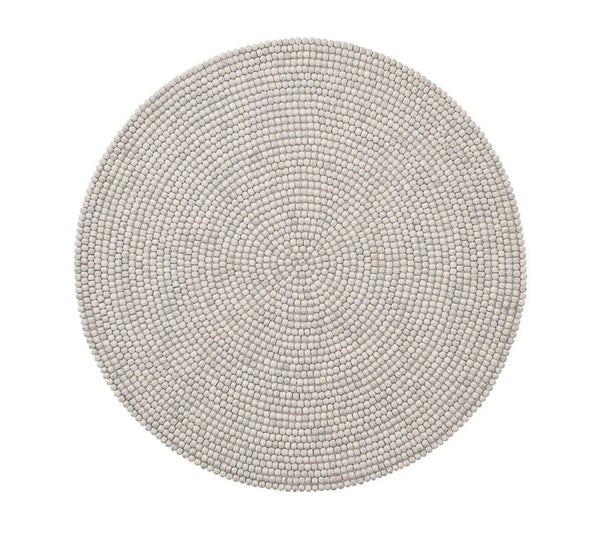 Round, light gray placemats from the Driftwood Placemat Set 4 Grey by Kim Seybert feature pebble-like texture and even design, offering a unique touch to handcrafted table decor or pairing beautifully with a beaded placemat. Seen from above on a white background.