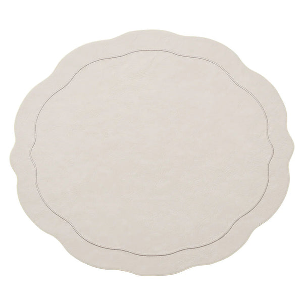 The Kim Seybert Tailored Placemat Set of 4 in Ivory features round, cream-colored faux leather mats with scalloped edges and a subtle stitched border, shown on a white background.