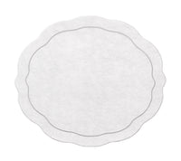 The Kim Seybert Tailored Placemat Set of 4 in Silver features round, white paper placemats with scalloped edges and a double-lined border, styled to evoke the elegance of silver, set against a plain background.