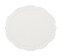 The Kim Seybert Tailored Placemat s/4 in White features a round shape with a wavy, scalloped edge and a subtle inner outline, shown here against a plain white background.