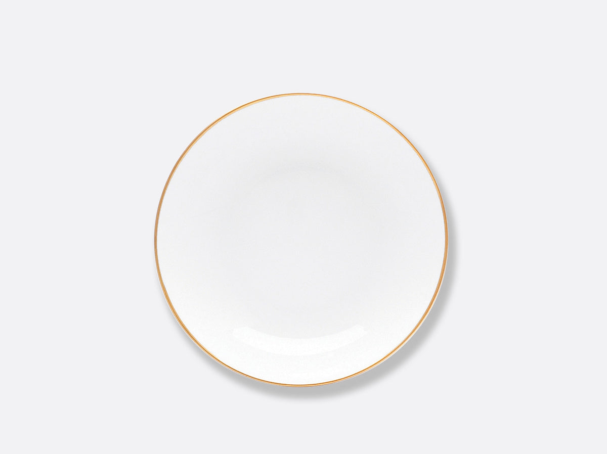The Bernardaud Palmyre Dinnerware features a plain white plate with a thin gold rim, centered on a light gray background—a perfect choice for a refined table with its understated appearance.
