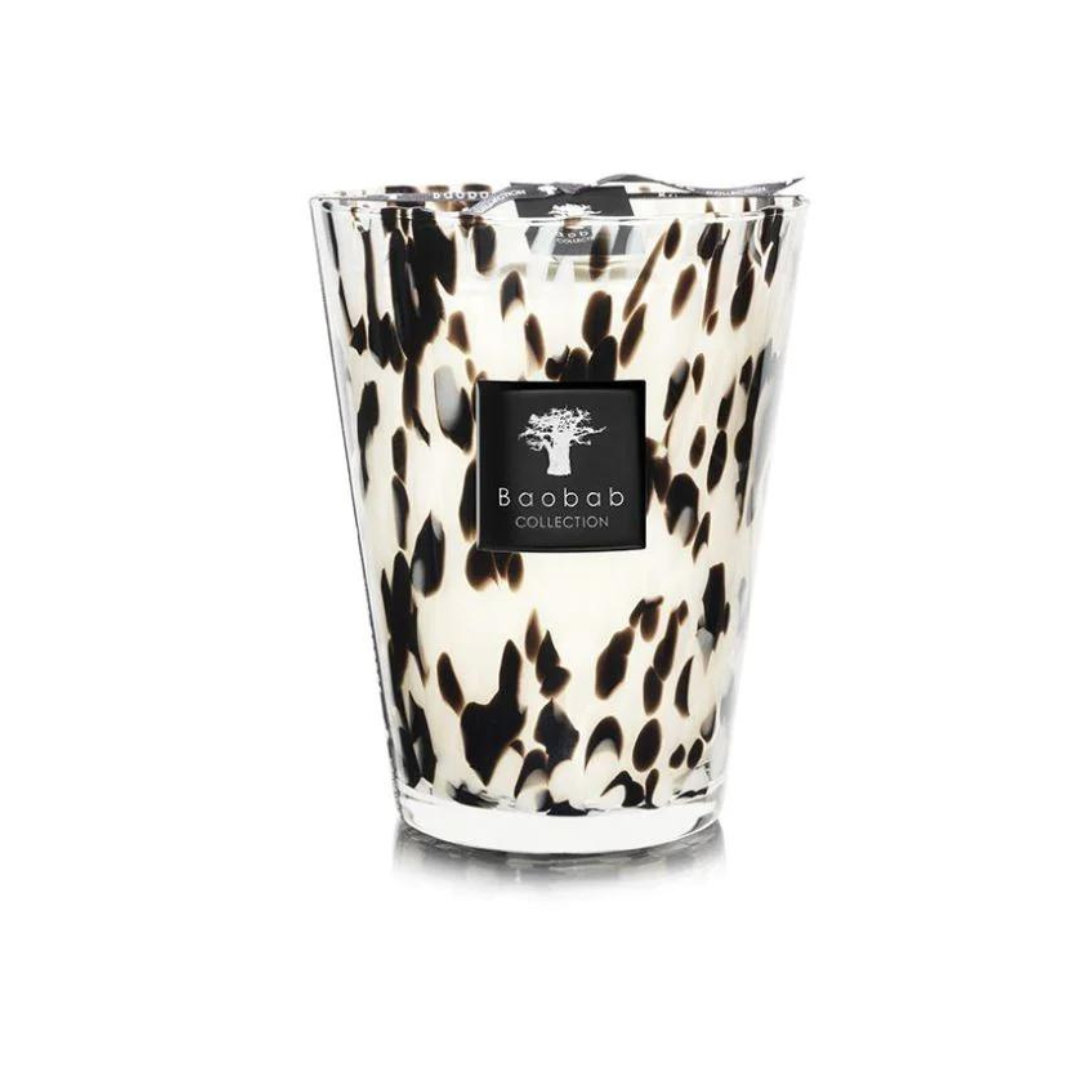 The Baobab Pearls Candle is a hand-blown glass candle holder with a black-and-white spotted design, featuring the Black Pearls scent and finished with the brand’s sleek black label logo.