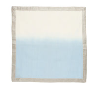 The Kim Seybert Dip Dye Napkins - Cool Tones (Set of 4) feature a square shape with a light gray border and a gradient design that fades from white at the top to light blue at the bottom.