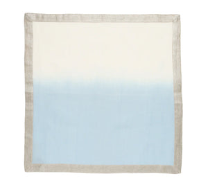 The Kim Seybert Dip Dye Napkins - Cool Tones (Set of 4) feature a square shape with a light gray border and a gradient design that fades from white at the top to light blue at the bottom.