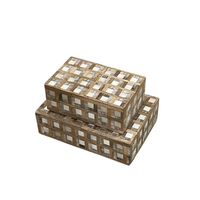 Two Plaid Wood and Bone Boxes by Bojay, featuring lids and a woven square pattern in light and dark brown tones, are stacked atop each other against a white background. These rustic boxes combine masculine storage with stylish design for your space.