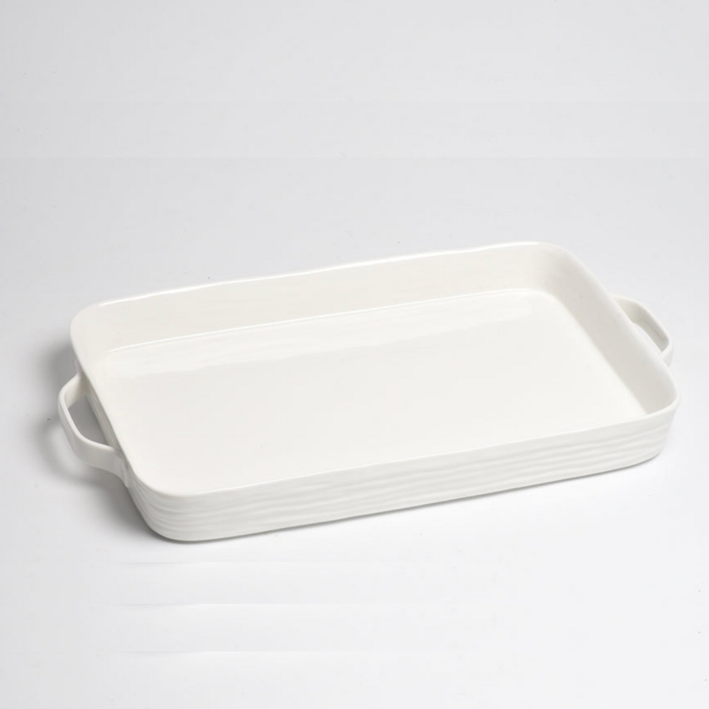 The PAMPA BAY Le Blanc Rectangle Handled Tray is a white ceramic oven-safe tray with handles on both sides, shown on a plain white surface.