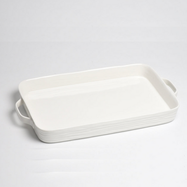 The PAMPA BAY Le Blanc Rectangle Handled Tray is a white ceramic oven-safe tray with handles on both sides, shown on a plain white surface.