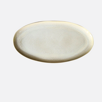The Plume White Dinnerware Pearl oval platter by Jars - Rosenthal features a subtle speckled pattern and light beige rim, shown on a plain white background.
