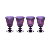 The Prism Wine Glass Set of 4 by L'Objet features four purple goblets with ribbed, fluted patterns and sturdy rounded bases. Their translucent design is perfect for any glassware collection.