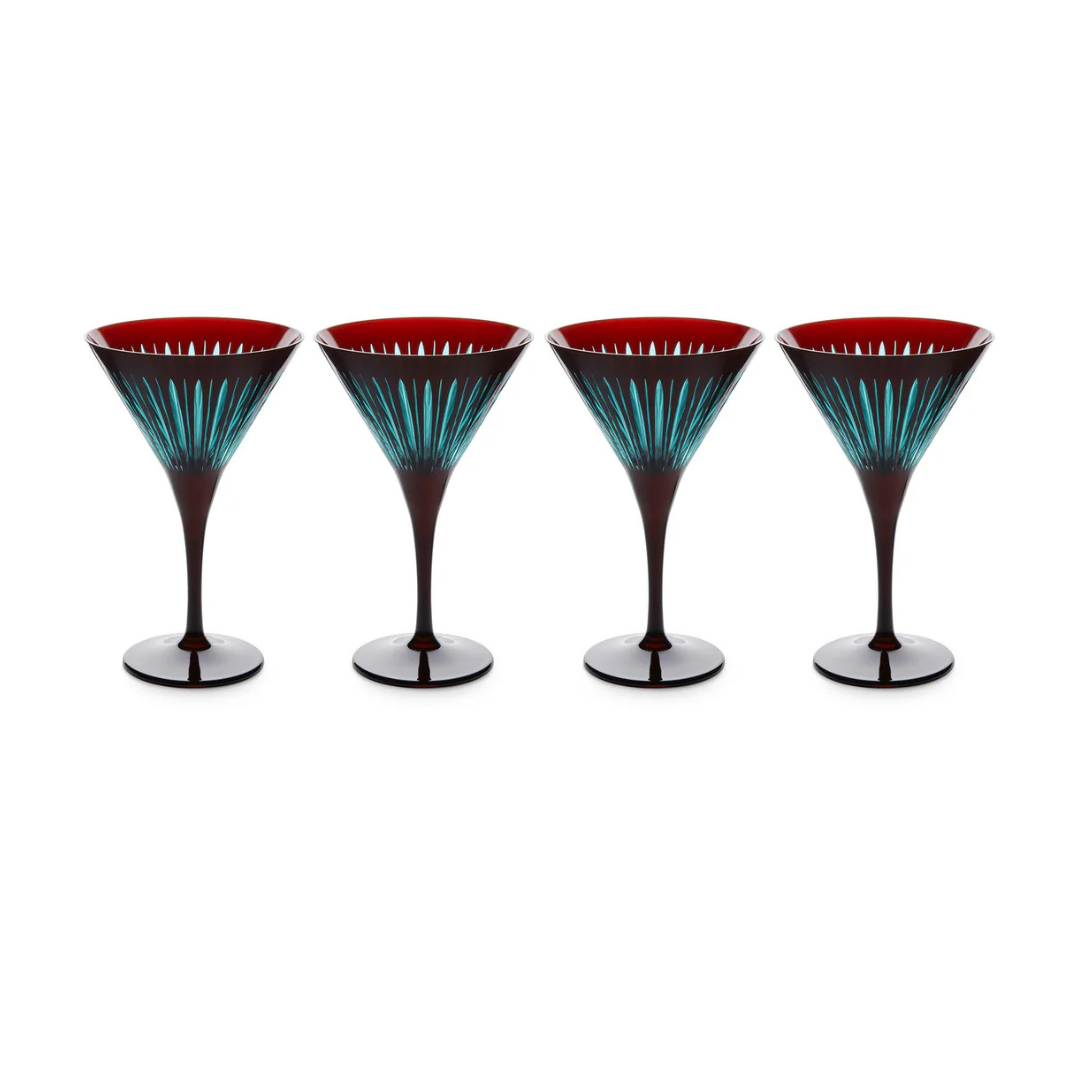 The Prism Martini Set of 4 by L'Objet features dark-stemmed glasses with red interiors and teal striped patterns, hand-cut details, and bold color accents, elegantly arranged in a row against a white background.
