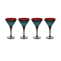 The Prism Martini Set of 4 by L'Objet features dark-stemmed glasses with red interiors and teal striped patterns, hand-cut details, and bold color accents, elegantly arranged in a row against a white background.