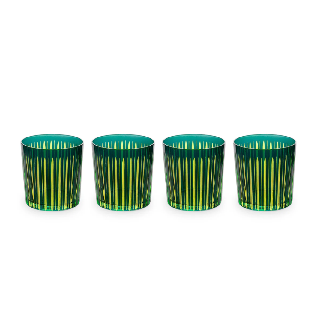 The Prism DOF Set of 4 by L'Objet features hand-cut glass tumblers with striking green and yellow stripes, elegantly arranged in a line on a white background to highlight their bold color design.