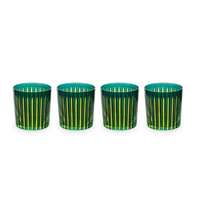 The Prism DOF Set of 4 by L'Objet features hand-cut glass tumblers with striking green and yellow stripes, elegantly arranged in a line on a white background to highlight their bold color design.