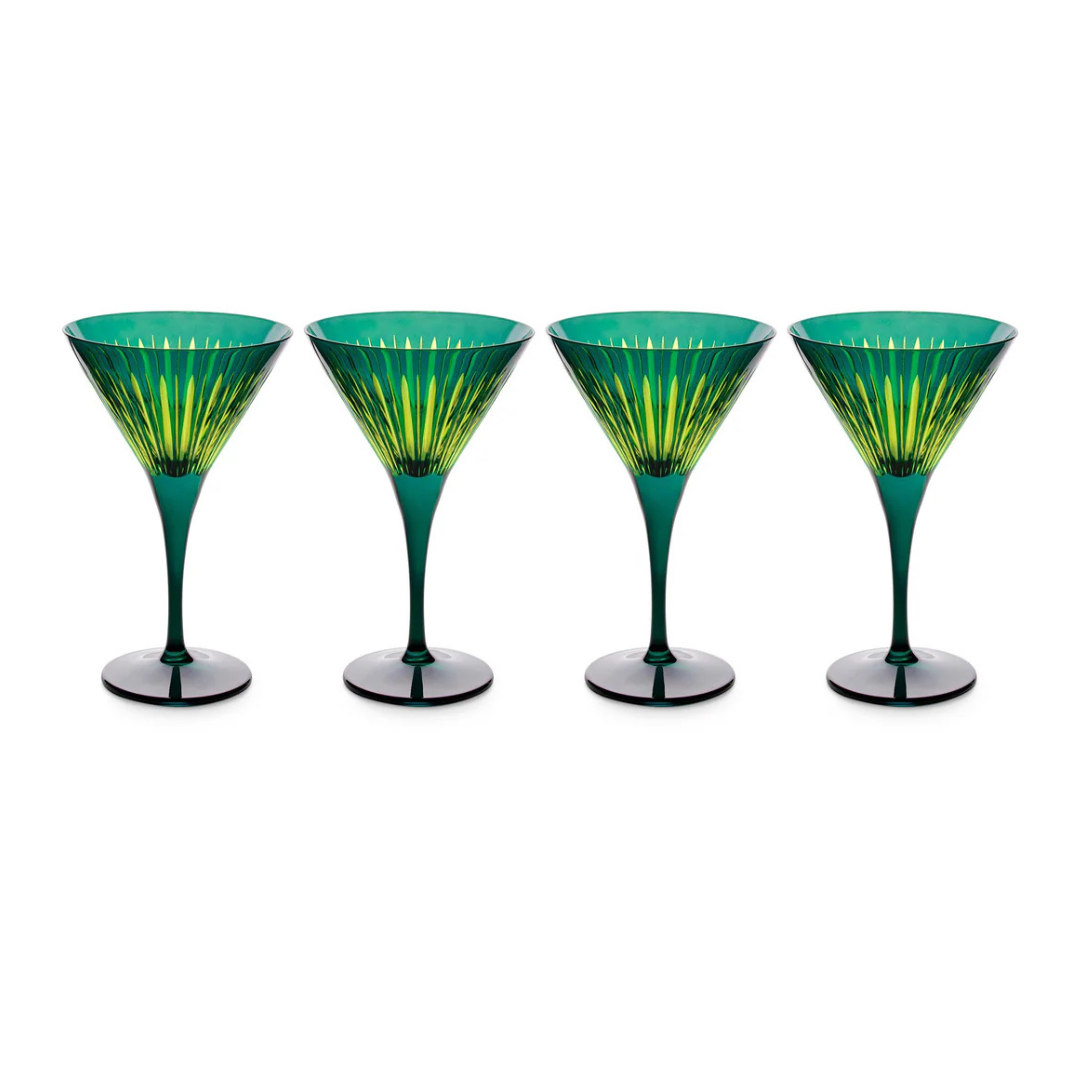 The Prism Martini Set of 4 by L'Objet features four green hand-cut glasses with flared rims, long stems, and a radiant yellow-green pattern inside each bowl, all displayed side by side on a white background.