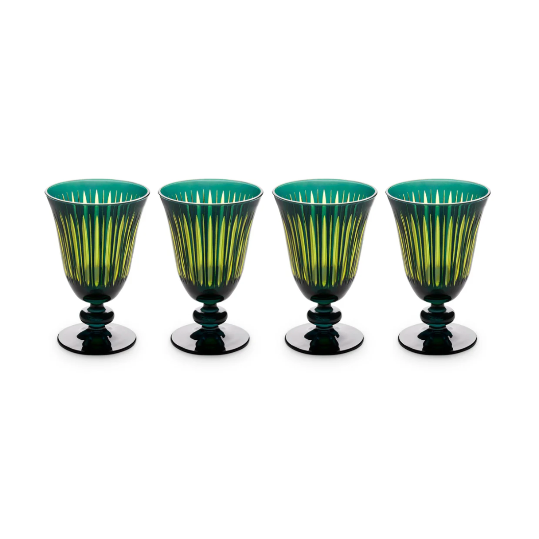 The Prism Wine Glass Set of 4 by L'Objet features green and yellow striped goblets with dark bases, arranged in a row against a white background for a vibrant addition to any glassware collection.