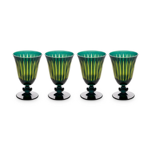 The Prism Wine Glass Set of 4 by L'Objet features green and yellow striped goblets with dark bases, arranged in a row against a white background for a vibrant addition to any glassware collection.