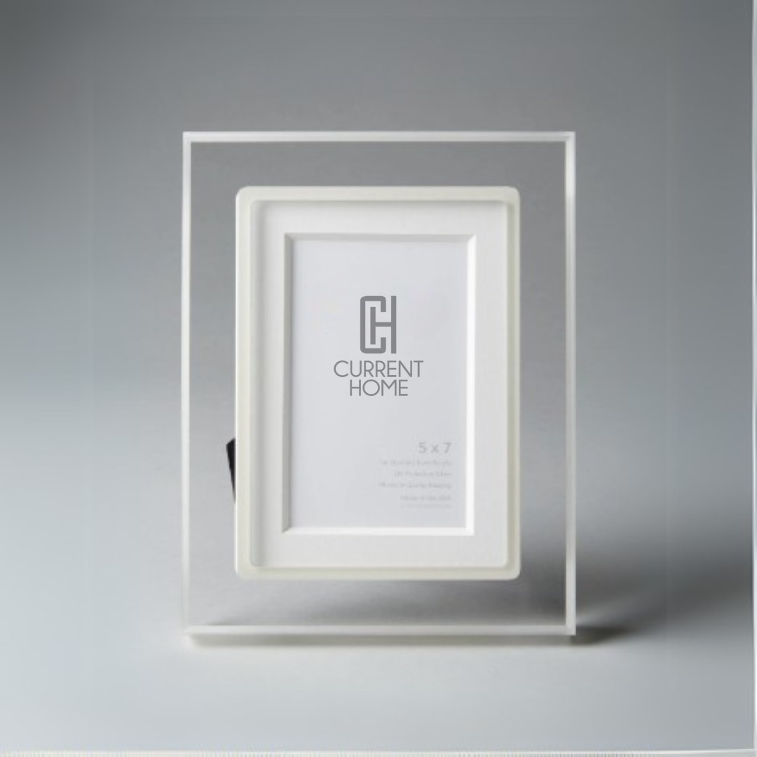 The Bella Moulding Prisma Frame Lip in Eggshell, made with archival materials, stands upright against a gray background and features a placeholder image displaying "Current Home" and the dimensions 5 x 7.