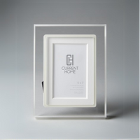 The Bella Moulding Prisma Frame Lip in Eggshell, made with archival materials, stands upright against a gray background and features a placeholder image displaying "Current Home" and the dimensions 5 x 7.
