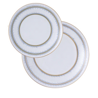 Two Marie Daâge Rafia 5 Dinnerware plates, featuring white porcelain with gold and blue rim details, are stacked on a white background, highlighting the luxurious design from the Marie Daâge collection.