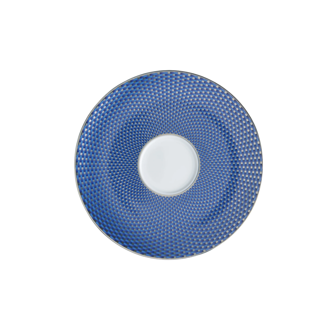 Tresor Dinnerware Blue by Raynaud features a round plate with a white center and a blue rim adorned with a geometric, checkered design. This elegant porcelain piece is shown from above against a white background.